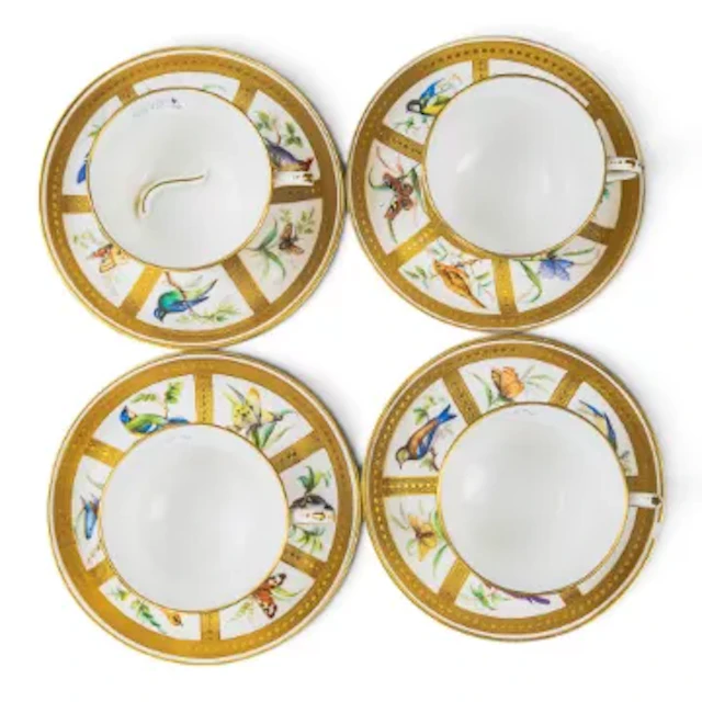 A group of 4 Minton cups & saucers, all decorated in panels featuring