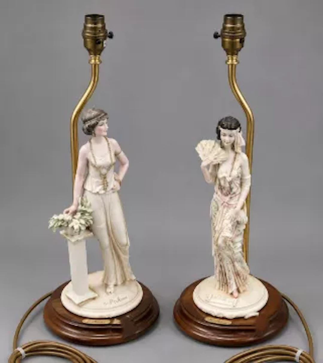 Two Belcari resin figural table lamps, Art Deco style ladies, raised