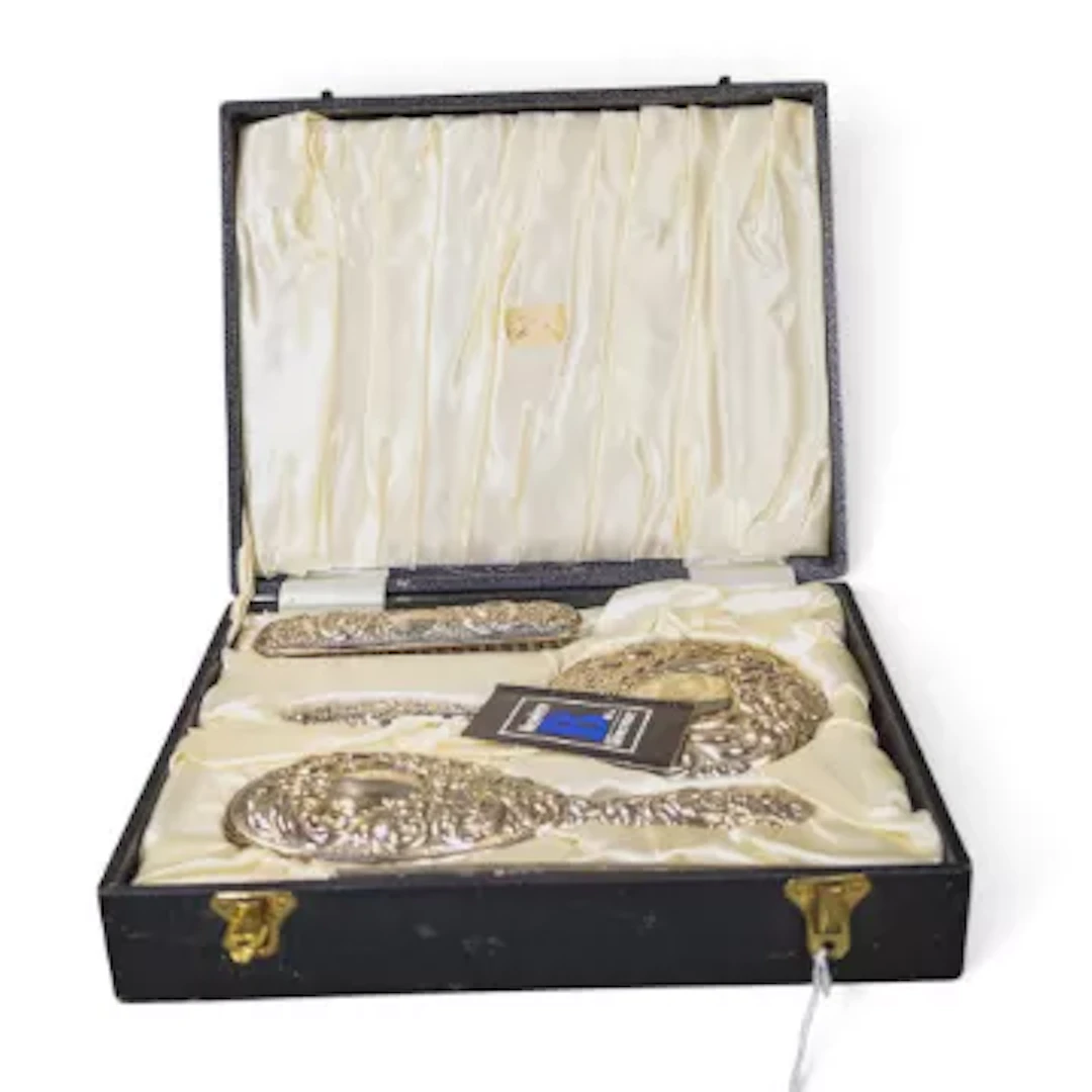Cased hallmarked silver backed dressing table set.