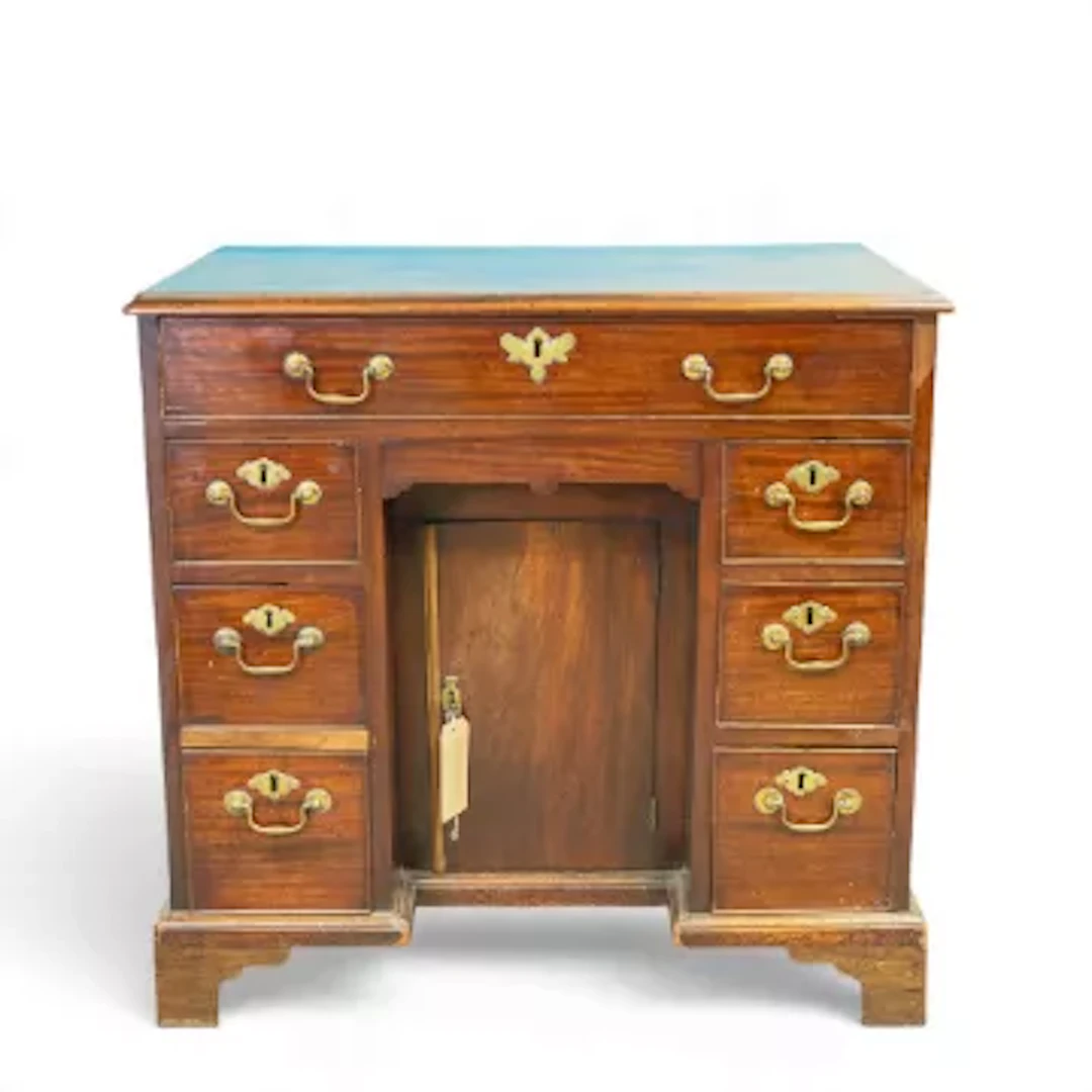 Georgian-style mahogany kneehole desk with a central cabinet door