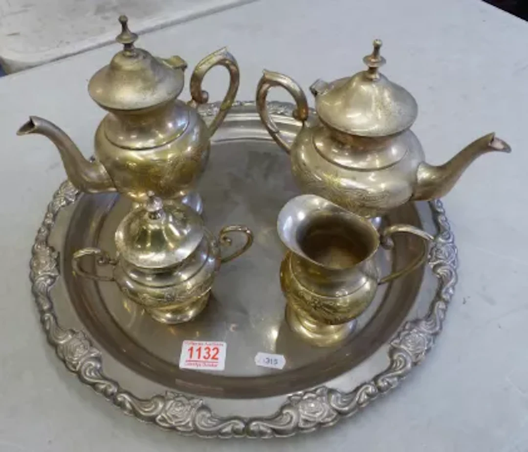 Silver plated four piece tea/coffee service on an ornate circular