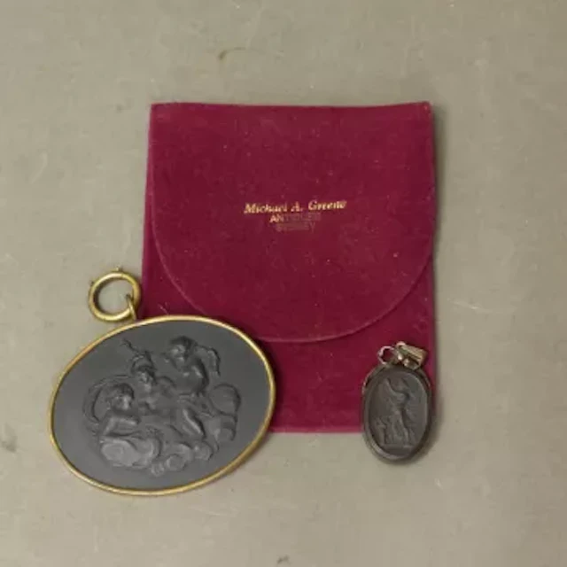 Two Wedgwood black basalt pendants, the larger of the two being early