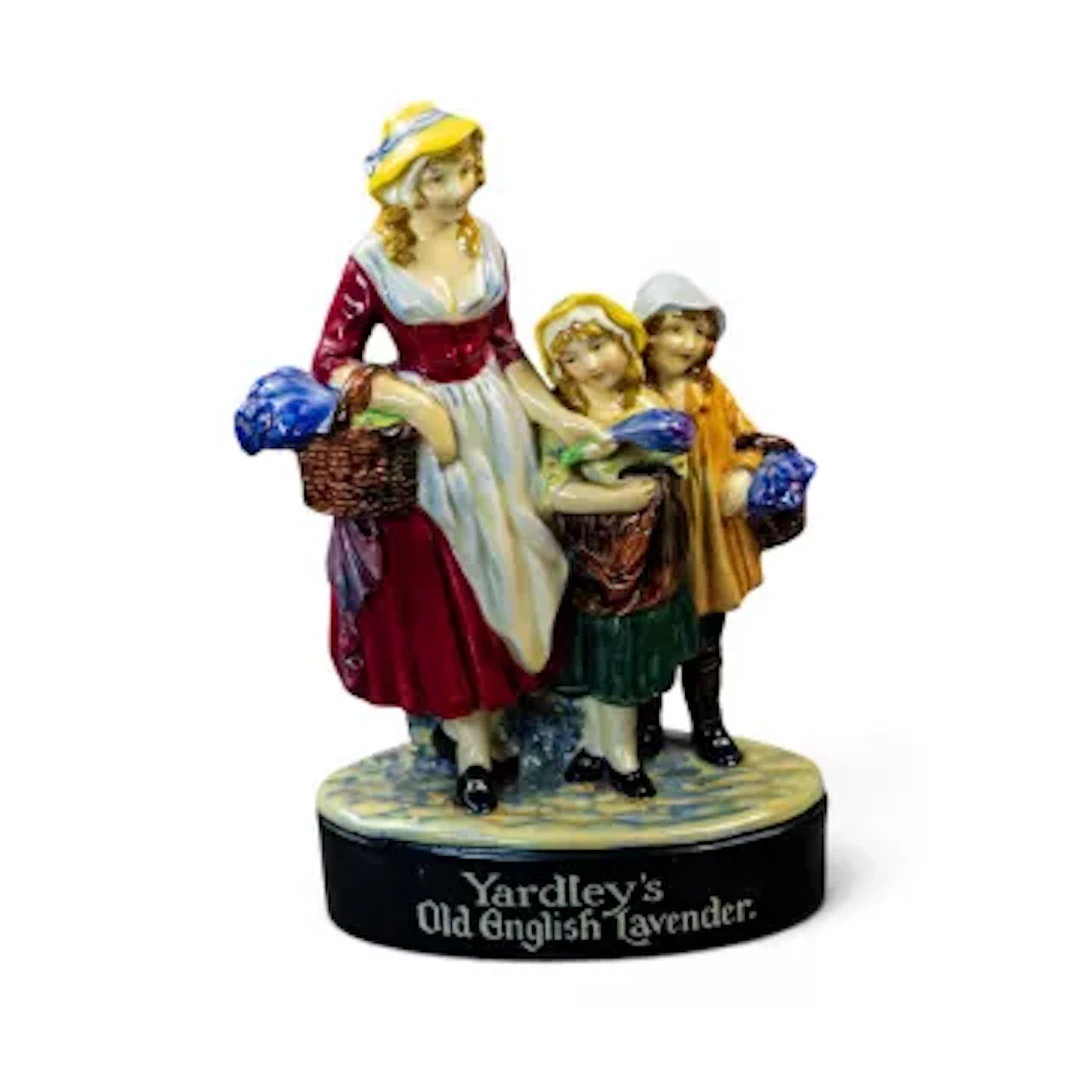 A Royal Doulton advertising figure group made for Yardley. A female