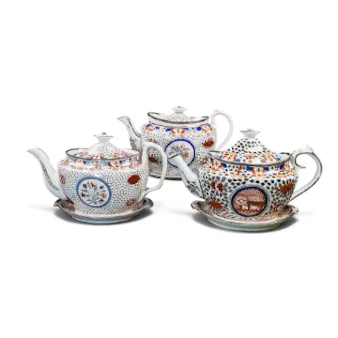 A group of 3 English porcelain 19th century teapots with stands, all
