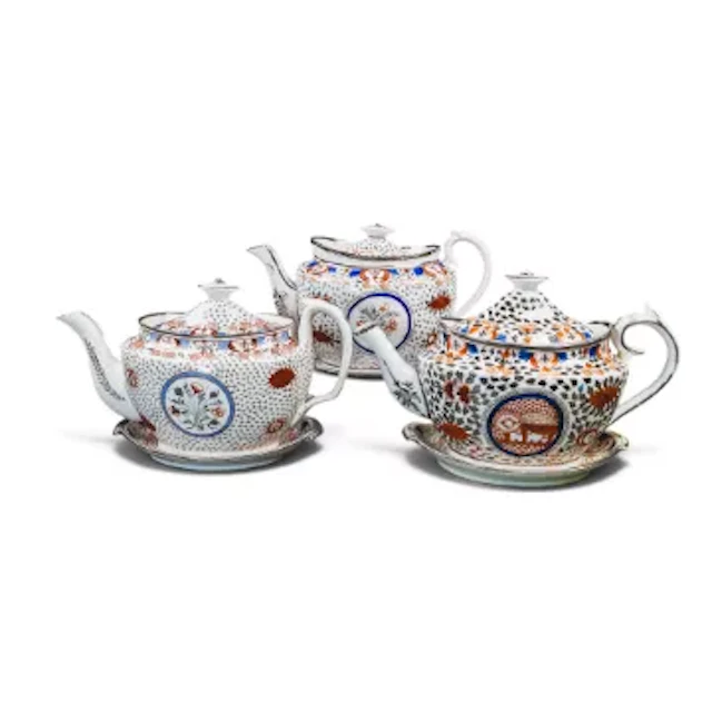 A group of 3 English porcelain 19th century teapots with stands, all