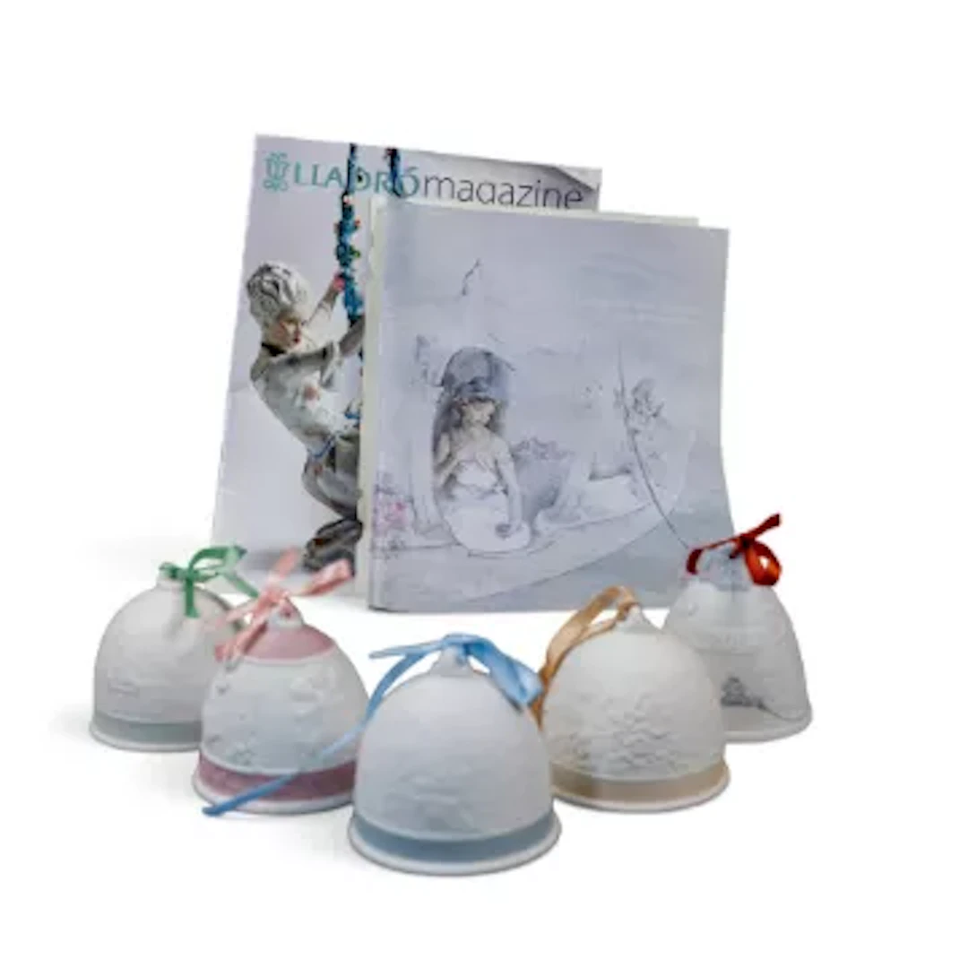 A group of five Lladro bells with ribbons, various embossed deigns