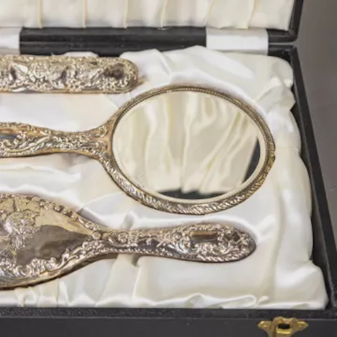 Cased hallmarked silver backed dressing table set.