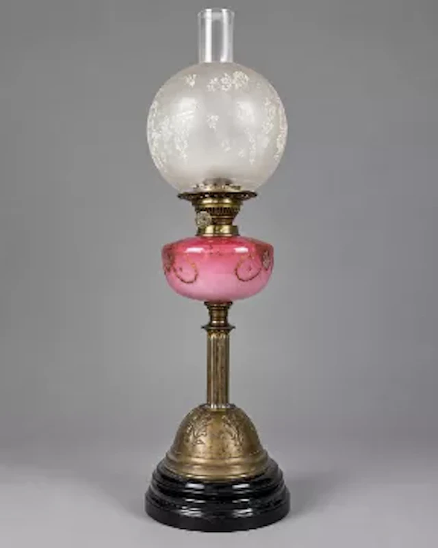 Victorian oil lamp of column form with a pink glass reservoir. With
