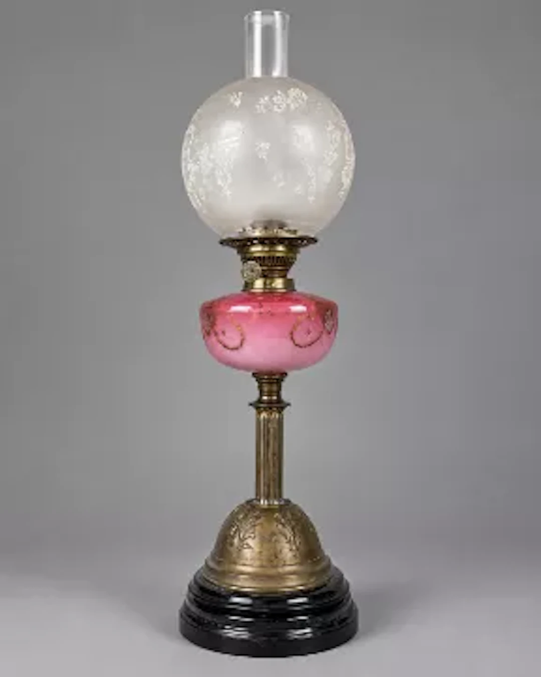 Victorian oil lamp of column form with a pink glass reservoir. With