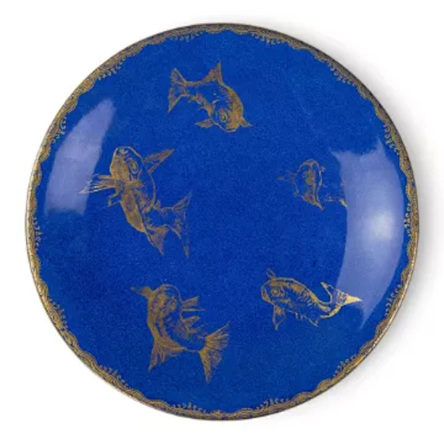 An early 20th Century Wedgwood plate with gilded fish against a powder
