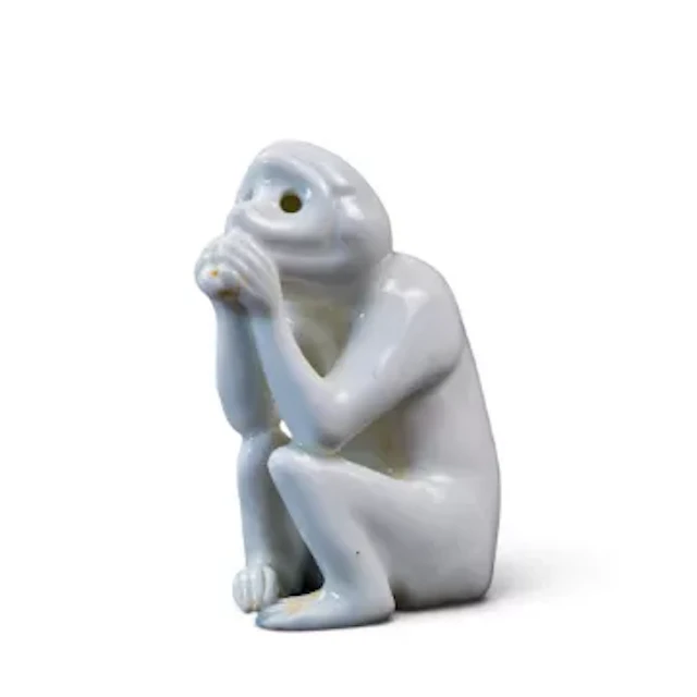 A Bernard Moore model of a sitting monkey, white China body, height 7cm.