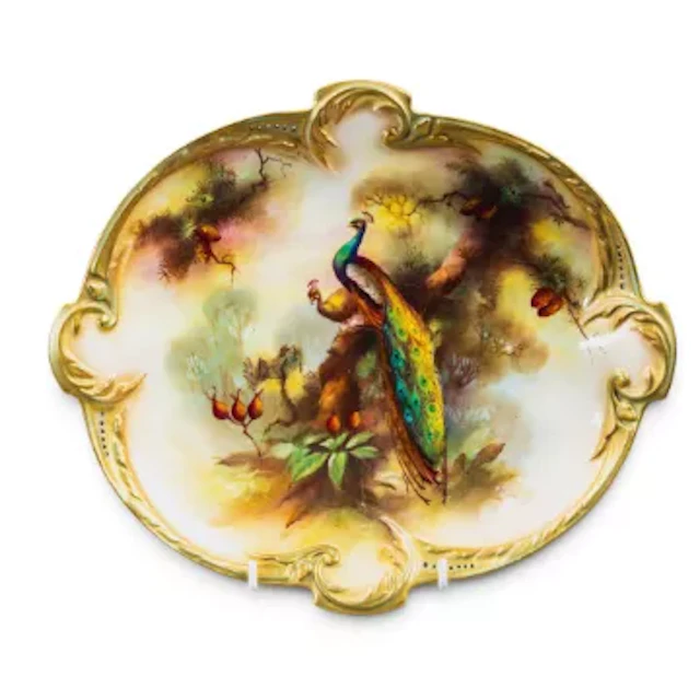 A Royal Worcester porcelain oval dish with shaped rim, hand decorated
