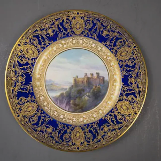 A Royal Worcester plate decorated with landscape scene of Harlech