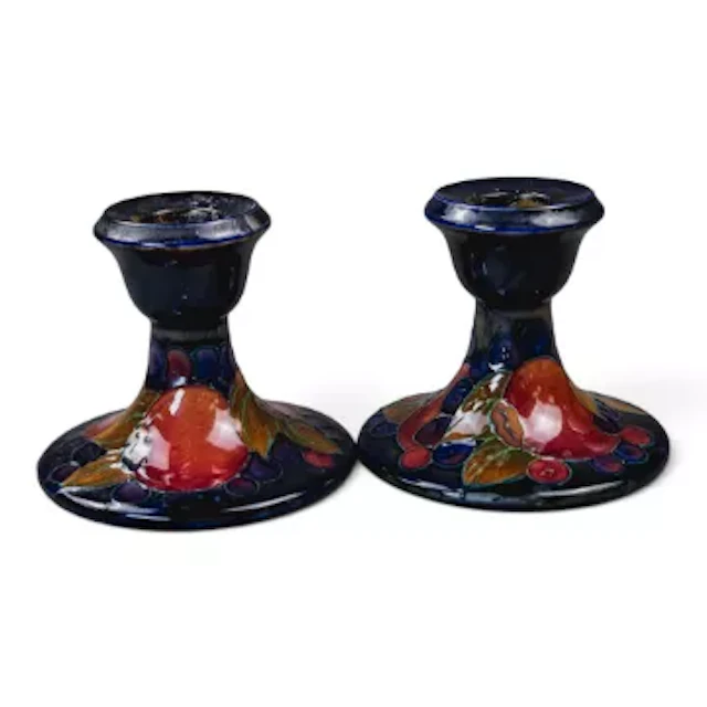 A pair of Moorcroft candlestick holders in the Pomegranate pattern
