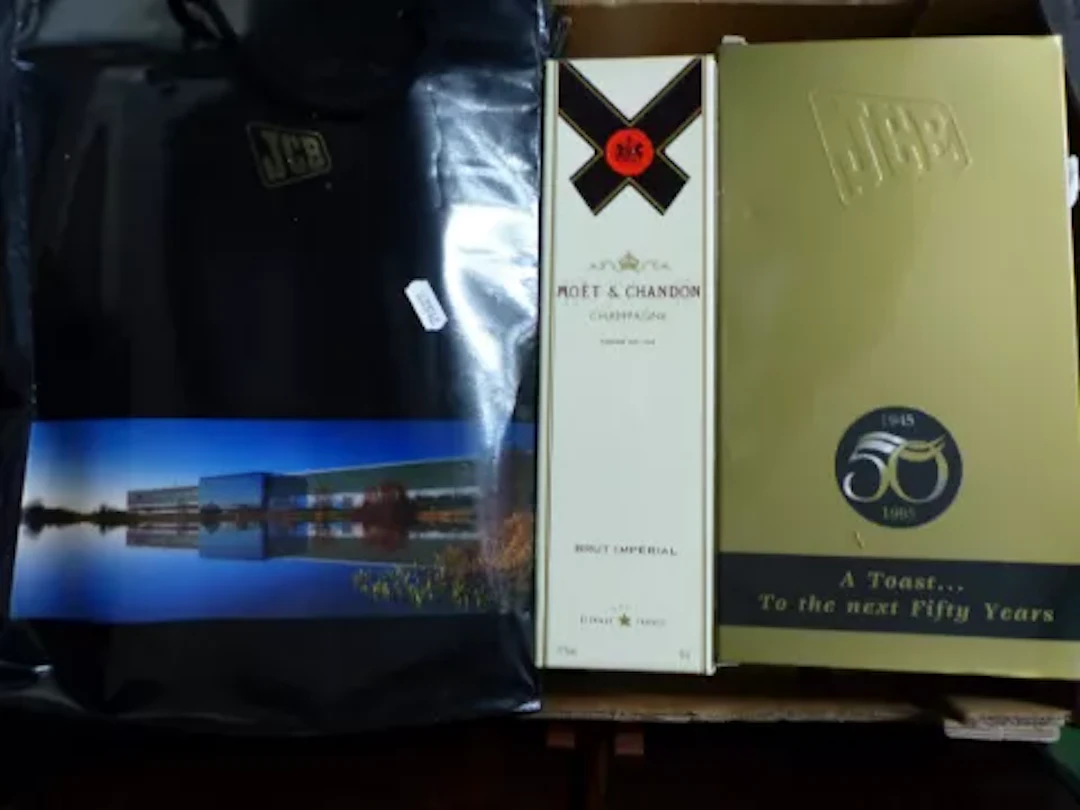 Two JCB branded gift sets celebrating 50 years and 65 years, one a