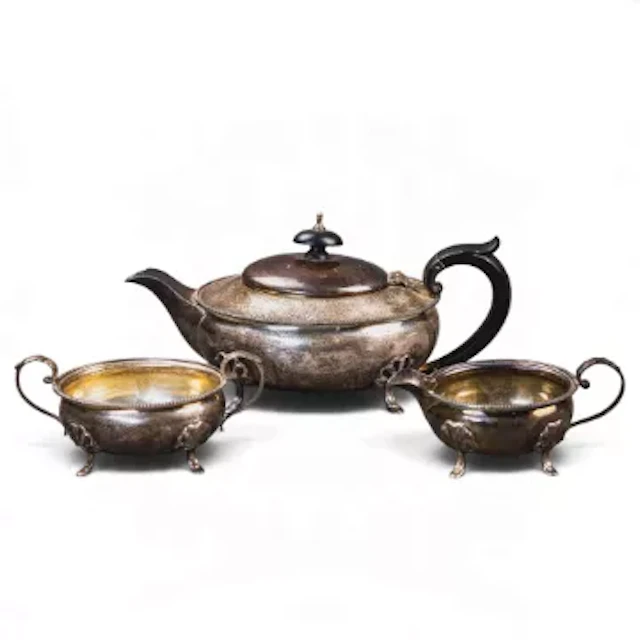 A three piece silver tea set, teapot, sugar & cream, each with cabriole