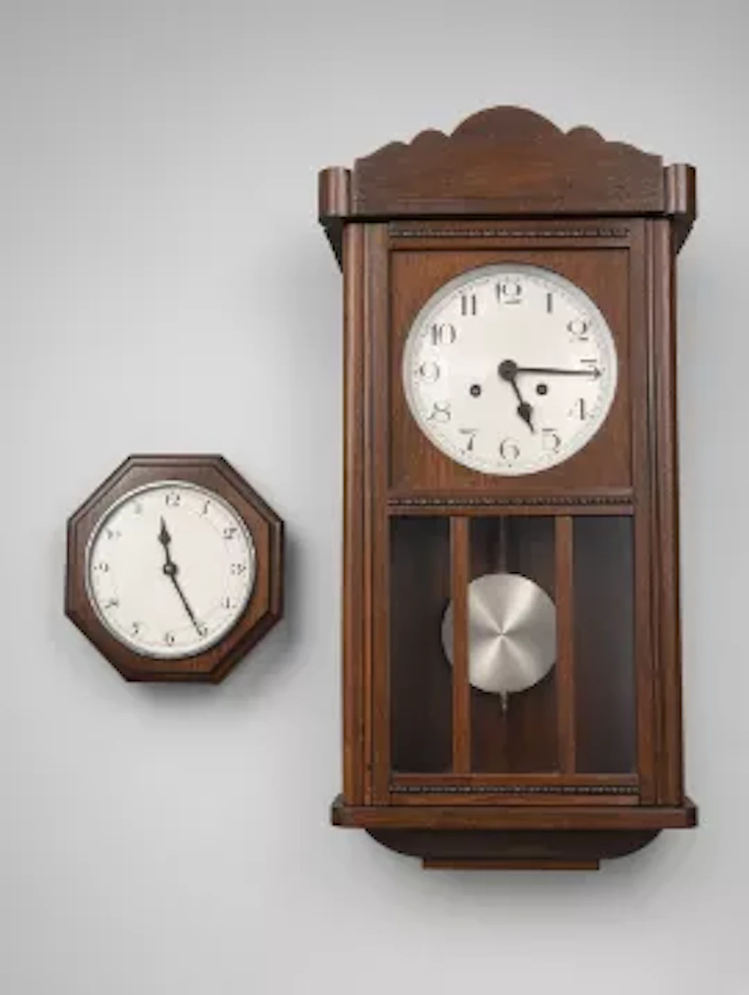A 20th century Oak-cased wall clock with shaped and scalloping cresting.