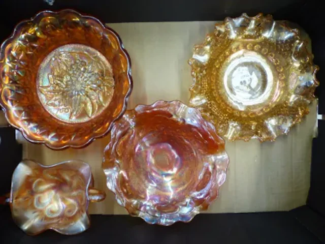 Four pieces of tangerine carnival glass (1 tray).