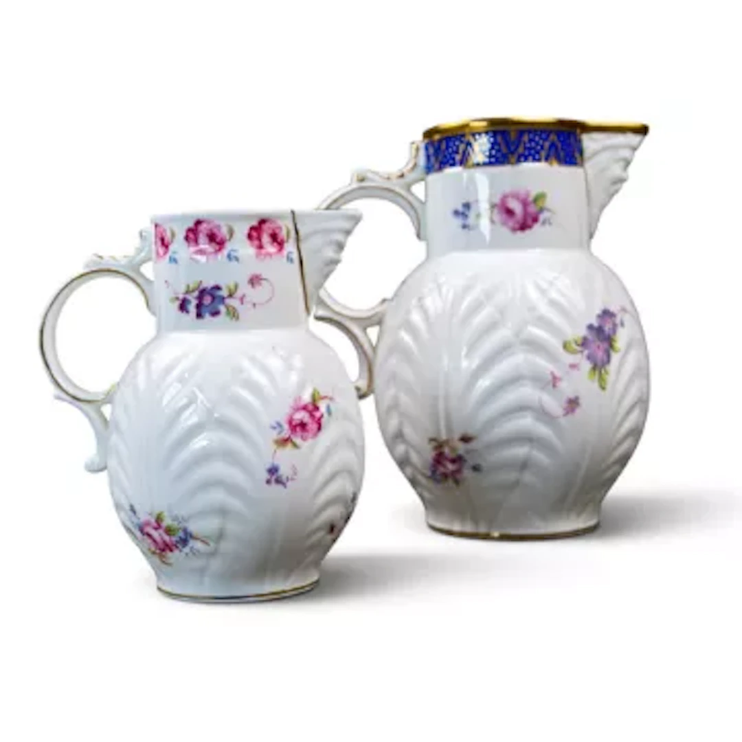 Two Coalport Jugs both decorated with floral sprays, both with embossed