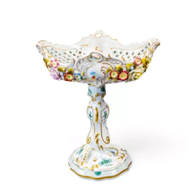 A continental porcelain tazza ornately decorated in the manner of