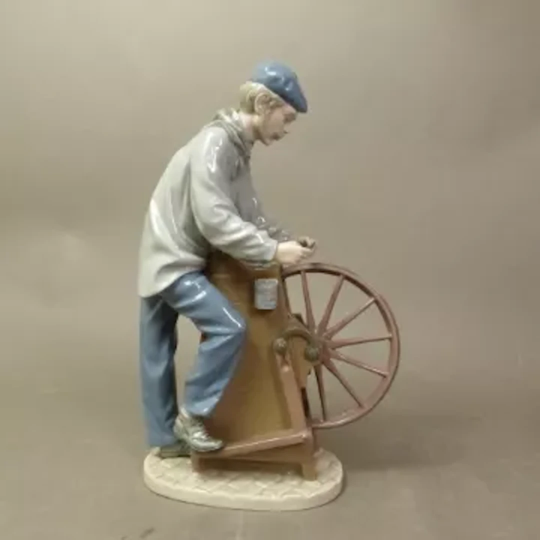 Lladro figure of a knife sharpener, model 5204, height 30cm.