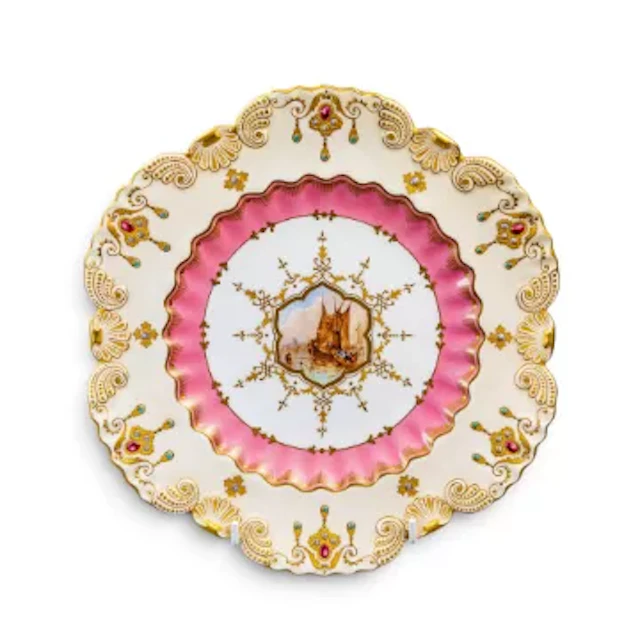 A late 19th Century Coalport plate with scalloped rim, ornately gilded