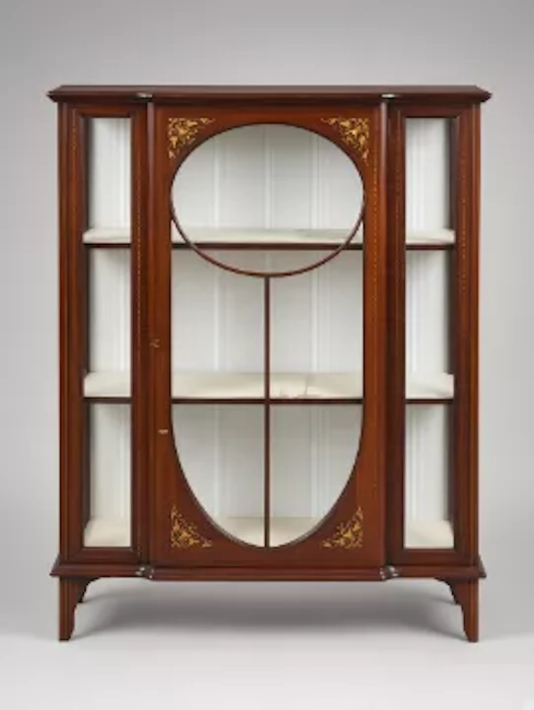 An early 20th century mahogany display cabinet raised on tapered legs.