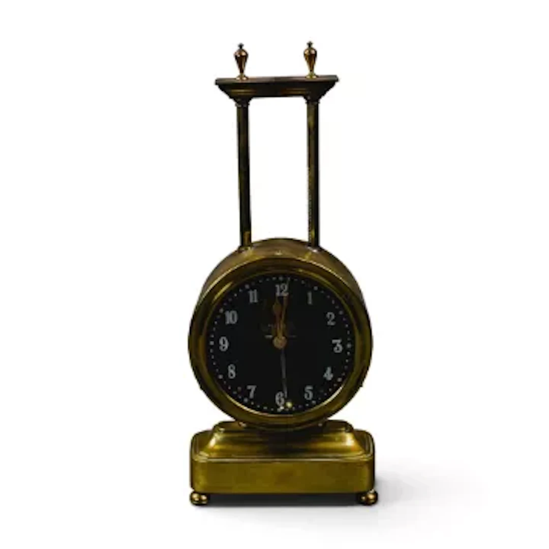 An early 20th century keyless Gravity clock, circular dial and casing