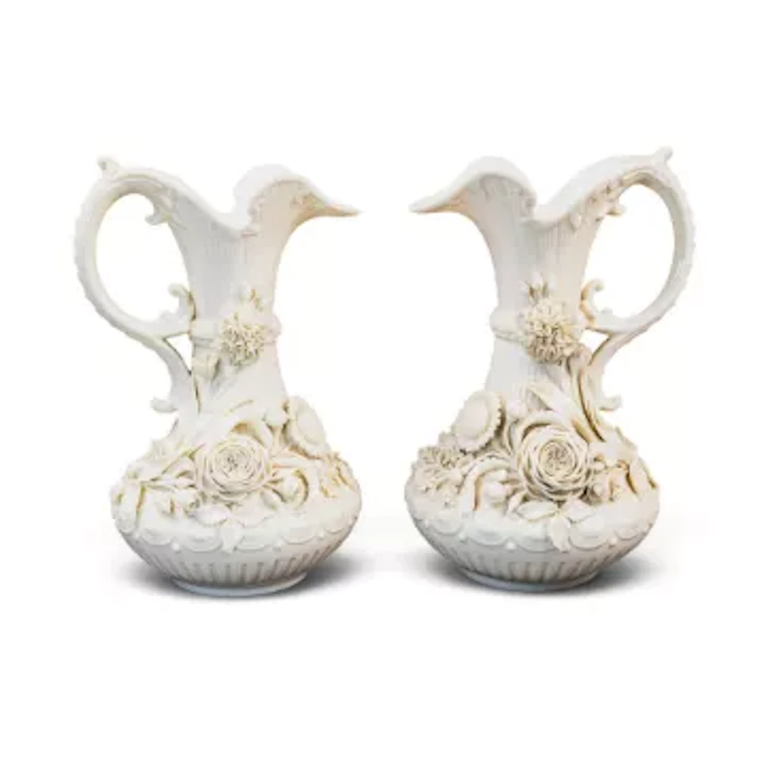 A pair of Belleek ewers (second period), with shaped & cut tops, both