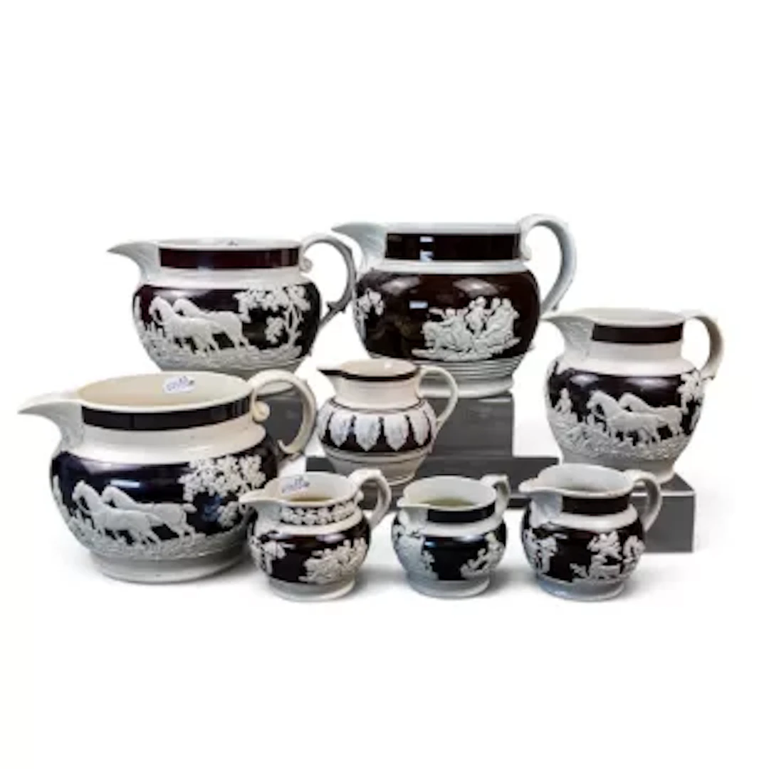 Eight English porcelain 19th century jugs, all decorated with embossed