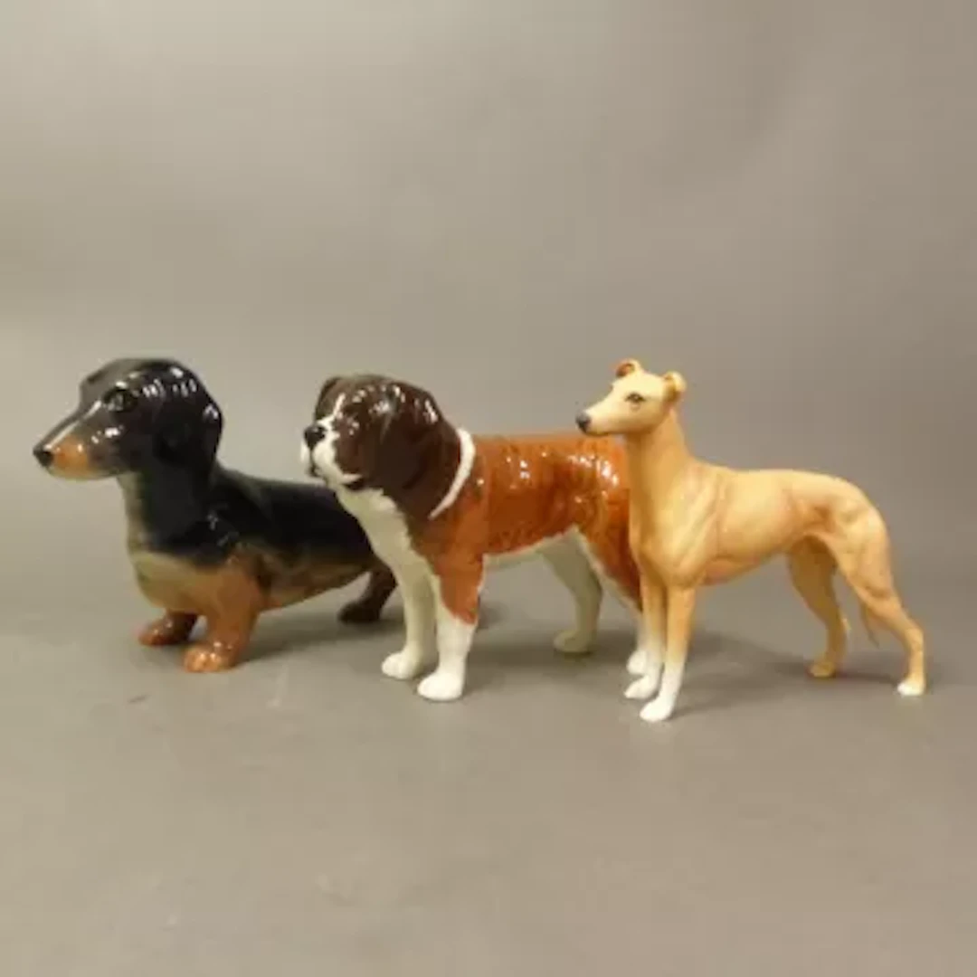 Three Beswick dog figures, Dachshund and St Bernard Corna Garth Stroller
