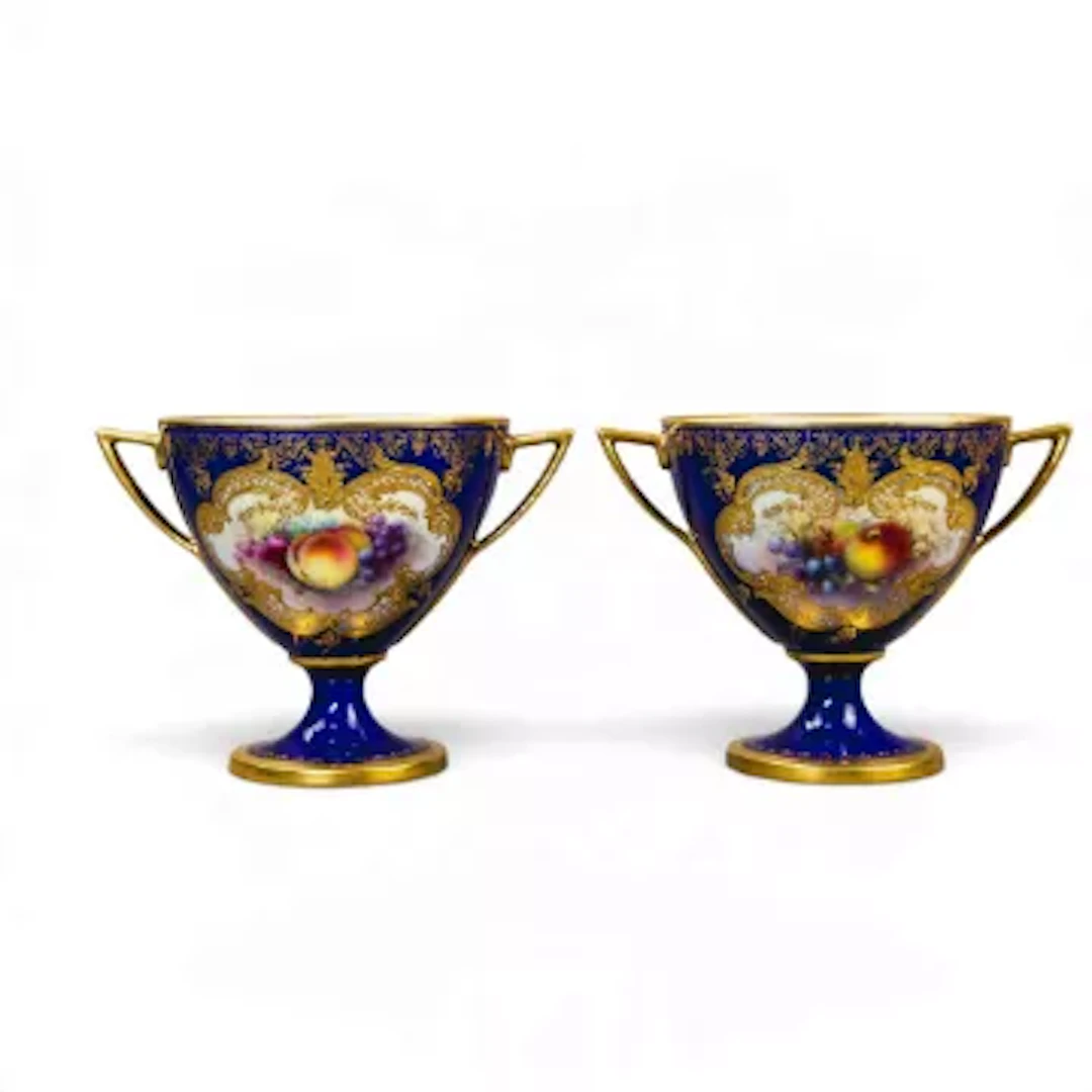 Two Royal Worcester twin handled vases, both decorated with panels