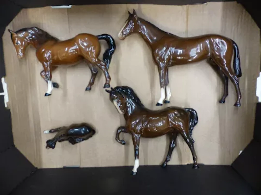 A collection of three Beswick brown gloss horses, model 701, Stocky