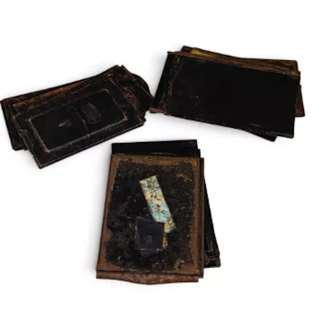 A collection of vintage metal photographic plate holders or darkslides
