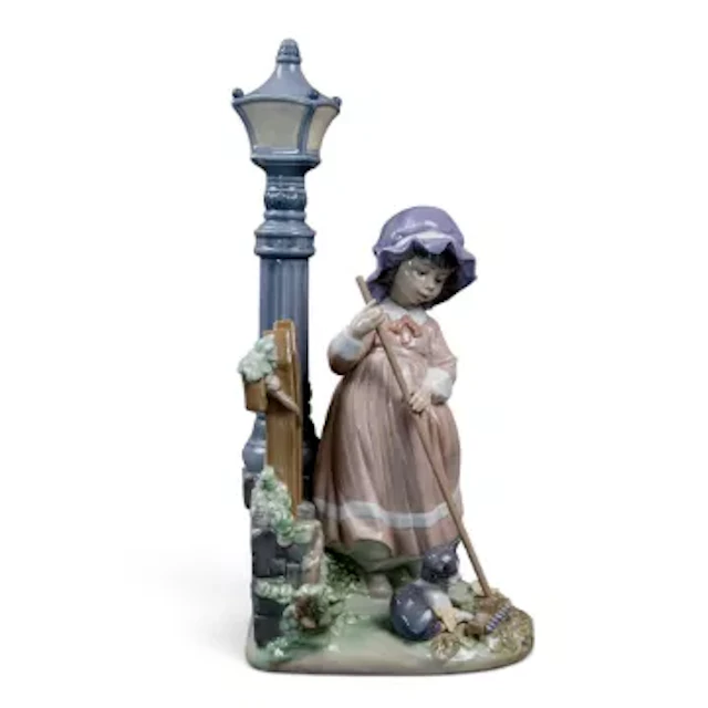 A Lladro figure 'Fall Clean up', model no.5286, designed by Jose Puche