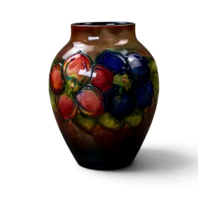 A Moorcroft vase in the Clematis design under a flambe glaze by Walter