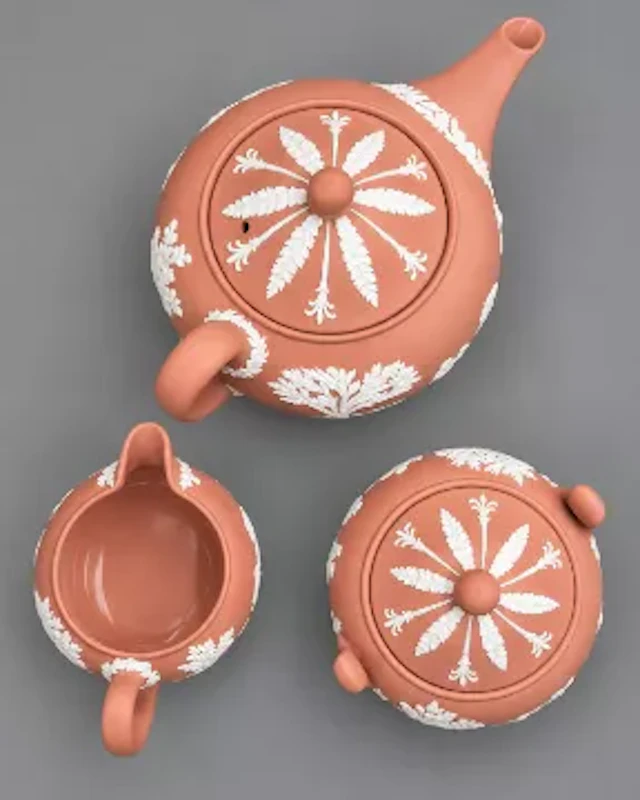 Wedgwood jasperware teapot, milk jug and a covered sugar bowl in terracotta