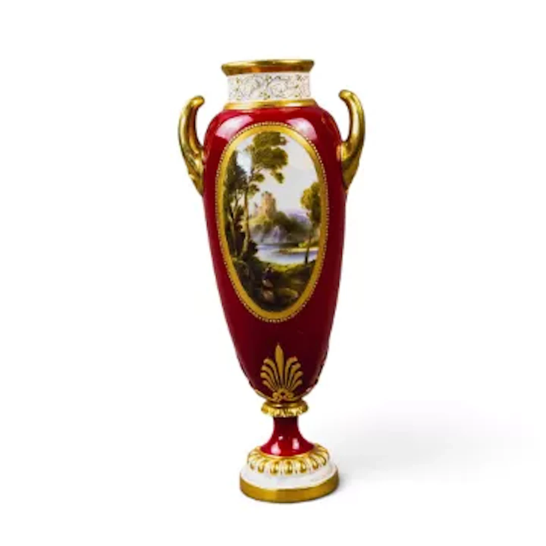 A Royal Worcester slender lidded vase with upswept twin handles, decorated
