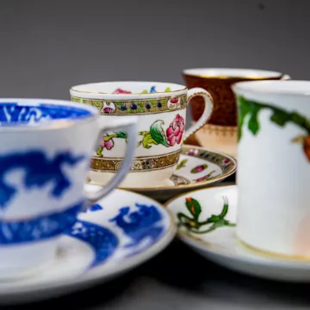A group of 12 cups & saucers by George Jones, Crescent China, in various