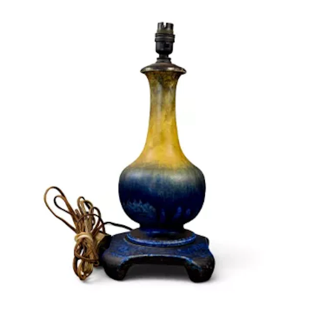 A Ruskin lamp on original four footed plinth, with yellow to blue