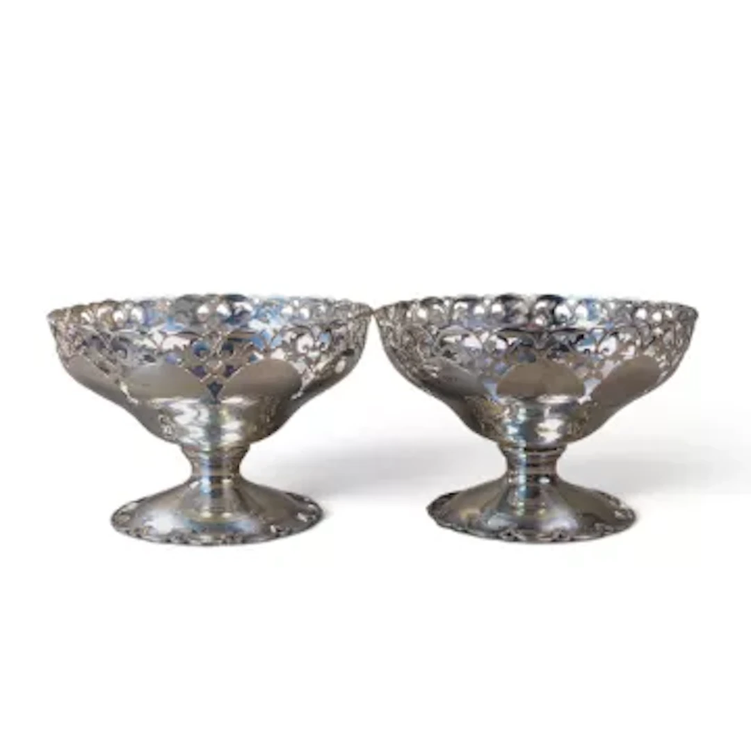 Pair of hallmarked sterling silver pierced dishes, 261g.