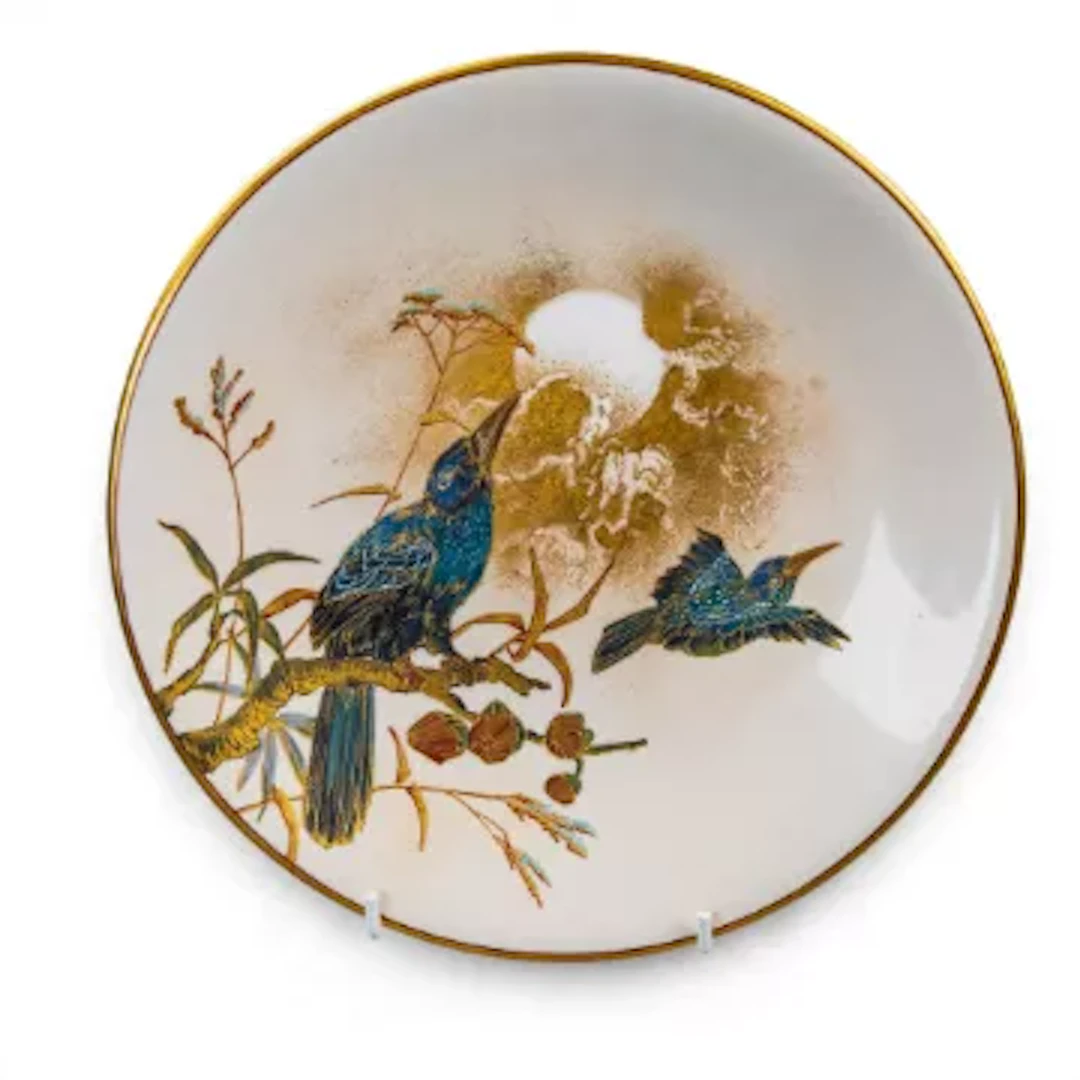 A Royal Worcester plate, decorated with a moonlit scene of a bird