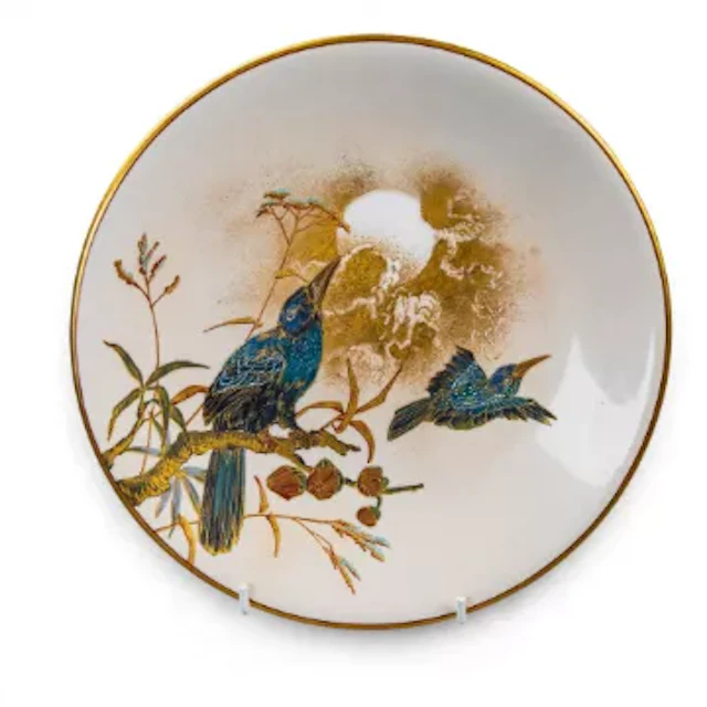 A Royal Worcester plate, decorated with a moonlit scene of a bird