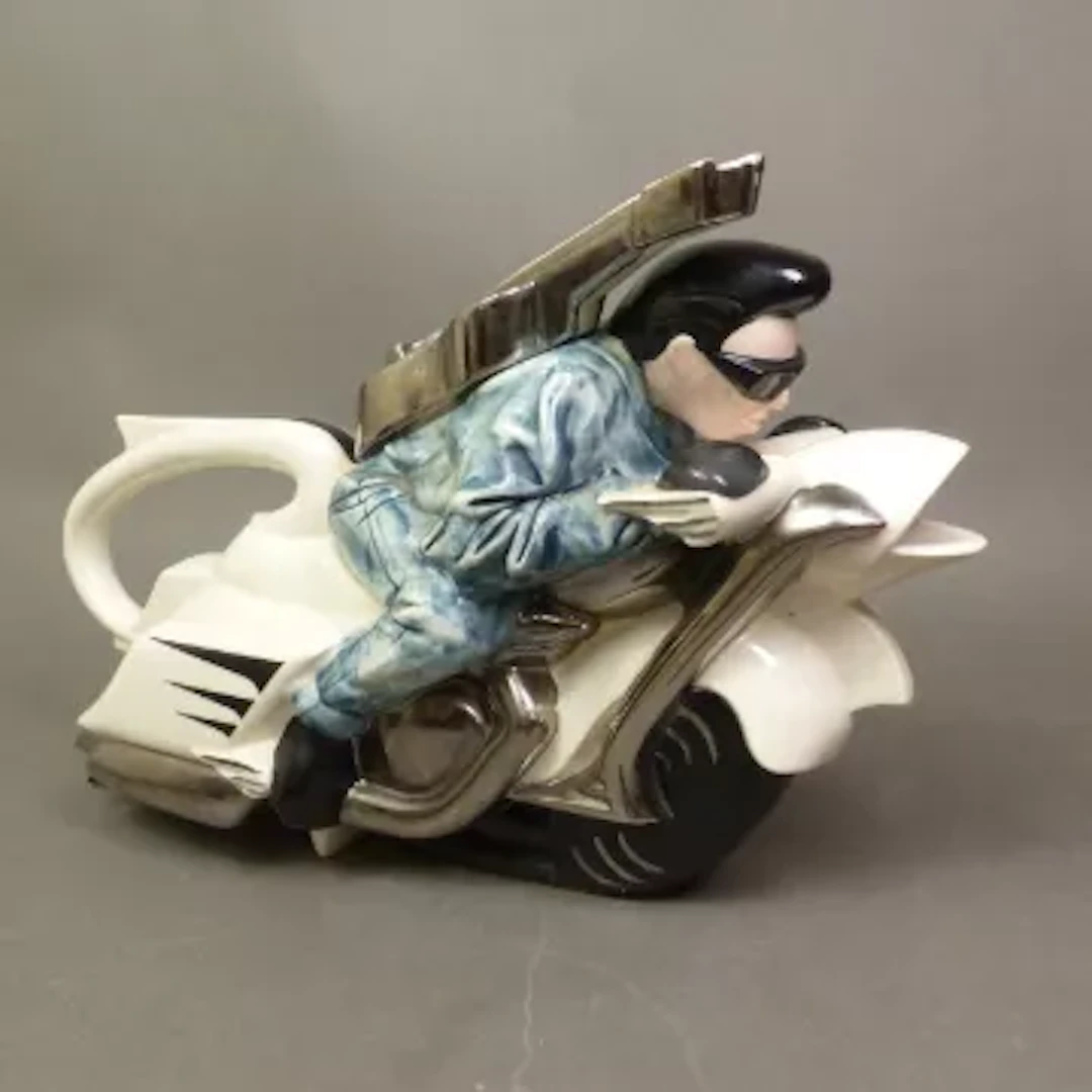 A Silver Crane ‘Rocker on a Motorbike’ novelty teapot, height 20cm.