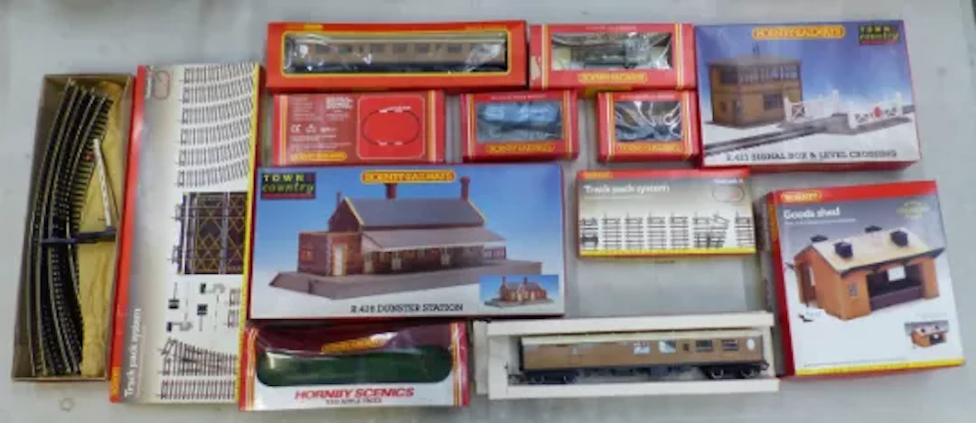 A collection of Hornby boxed rolling stock, a R.300 locomotive, station