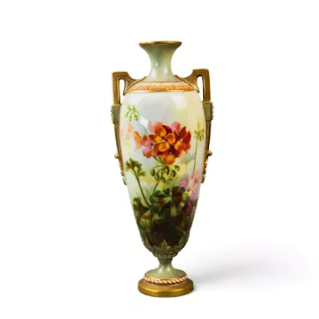 A Royal Worcester urn shaped vase on a pedestal foot with twin handles