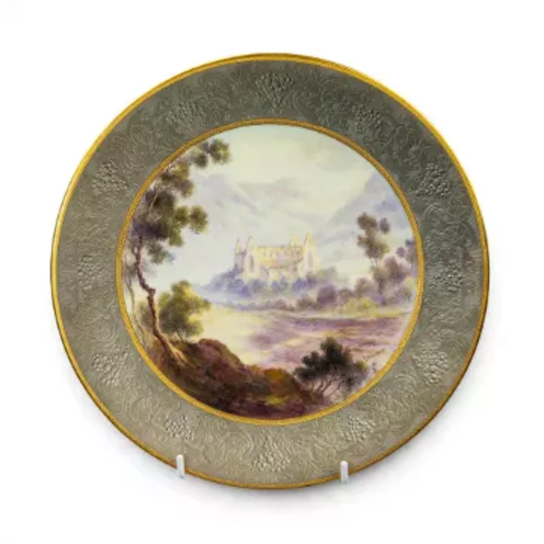A Royal Worcester plate, decorated with landscape scene featuring
