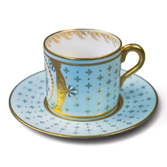 A Lynton porcelain cup and saucer, ornately decorated with turquoise