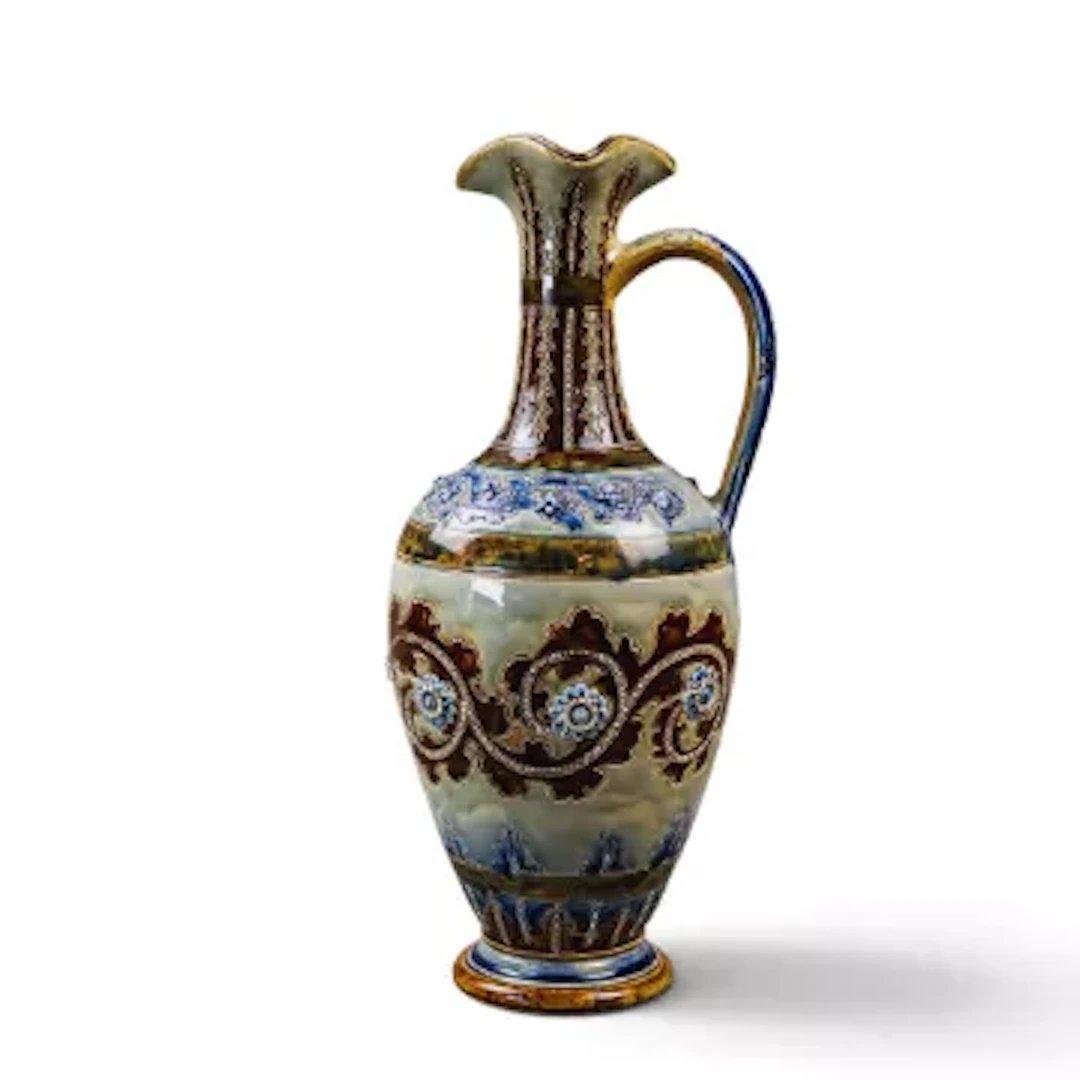 A large Doulton Lambeth ewer with a looped handle and shaped rim by