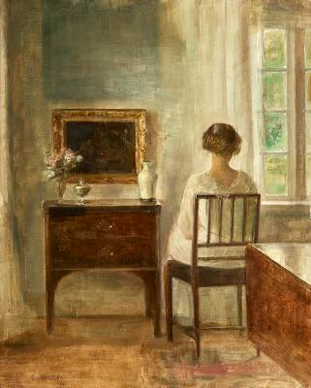 Carl Holsøe: Interior with a young woman sitting by a window. Signed